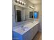 Bathroom with double vanity, large mirror, and updated fixtures at 10138 W Highland Ave, Phoenix, AZ 85037