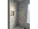 Modern marble shower with a niche at 10138 W Highland Ave, Phoenix, AZ 85037
