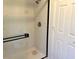 Clean bathroom with a shower and white tile at 10138 W Highland Ave, Phoenix, AZ 85037