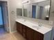 Double sink bathroom with dark wood cabinets at 10138 W Highland Ave, Phoenix, AZ 85037