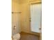 Small bathroom with toilet and exterior door at 10138 W Highland Ave, Phoenix, AZ 85037