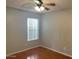 Simple bedroom with wood floors and ceiling fan at 10138 W Highland Ave, Phoenix, AZ 85037