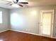 Well-lit bedroom with wood flooring and private door at 10138 W Highland Ave, Phoenix, AZ 85037