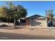 Ranch style home with a two-car garage and mature landscaping at 10138 W Highland Ave, Phoenix, AZ 85037