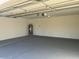 Garage with painted floor and extra storage space at 10138 W Highland Ave, Phoenix, AZ 85037