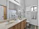 Bathroom with double sinks, wood cabinets, and a shower/tub combo at 1040 N 113Th Pl, Mesa, AZ 85207