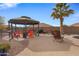 Relaxing gazebo with colorful seating and fire pit at 1040 N 113Th Pl, Mesa, AZ 85207