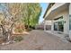 Backyard with gravel, mature trees, and a patio at 10634 W Mohawk Ln, Peoria, AZ 85382