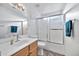 Clean bathroom with a tub shower, vanity, and a large mirror at 10634 W Mohawk Ln, Peoria, AZ 85382