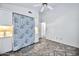 Bright bedroom with tile flooring, ceiling fan, and ample closet space at 10634 W Mohawk Ln, Peoria, AZ 85382