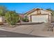 House exterior showcasing a two-car garage and desert landscaping at 10634 W Mohawk Ln, Peoria, AZ 85382