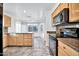 Spacious kitchen with light wood cabinets, granite countertops, and stainless steel appliances at 10634 W Mohawk Ln, Peoria, AZ 85382