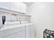 Laundry room with washer, dryer, and overhead storage at 10634 W Mohawk Ln, Peoria, AZ 85382