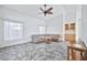 Living room with vaulted ceiling, tile floors, and built-in wet bar at 10634 W Mohawk Ln, Peoria, AZ 85382