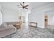 Living room with vaulted ceiling, tile floors, and built-in wet bar at 10634 W Mohawk Ln, Peoria, AZ 85382