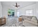 Living room with tile floor, sectional sofa, and backyard access at 10634 W Mohawk Ln, Peoria, AZ 85382