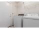 Laundry room with washer, dryer, and overhead shelving at 11589 N 110Th Pl, Scottsdale, AZ 85259