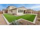 Artificial turf lawn, covered patio, and gravel landscaping at 11667 W Marguerite Ave, Avondale, AZ 85323