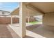 Covered patio area with artificial turf and brick pavers at 11667 W Marguerite Ave, Avondale, AZ 85323