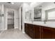 Double vanity bathroom with dark wood cabinets at 11667 W Marguerite Ave, Avondale, AZ 85323