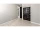 Simple bedroom with neutral walls and wood-look tile floors, and double doors to closet at 11667 W Marguerite Ave, Avondale, AZ 85323