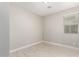 Well-lit bedroom featuring neutral walls and wood-look tile floors at 11667 W Marguerite Ave, Avondale, AZ 85323