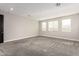 Large bedroom with carpet and multiple windows at 11667 W Marguerite Ave, Avondale, AZ 85323