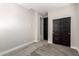 Bright bedroom with neutral walls and carpet flooring, and double doors to closet at 11667 W Marguerite Ave, Avondale, AZ 85323
