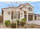 Two-story house with two-car garage and landscaping at 11667 W Marguerite Ave, Avondale, AZ 85323