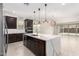 Open concept kitchen with island and breakfast bar at 11667 W Marguerite Ave, Avondale, AZ 85323