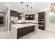 Modern kitchen with large island, stainless steel appliances, and dark cabinetry at 11667 W Marguerite Ave, Avondale, AZ 85323