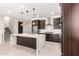 Gourmet kitchen featuring dark cabinetry and quartz countertops at 11667 W Marguerite Ave, Avondale, AZ 85323