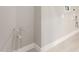 Bright laundry room with white walls and light wood-look flooring at 11667 W Marguerite Ave, Avondale, AZ 85323