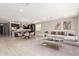 Open living room and kitchen with neutral color palette and modern furnishings at 11667 W Marguerite Ave, Avondale, AZ 85323