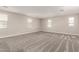 Spacious loft area with carpet flooring and multiple windows at 11667 W Marguerite Ave, Avondale, AZ 85323