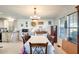 Dining area with floral tablecloth and chandelier, open to kitchen at 120 N Val Vista Dr # 186, Mesa, AZ 85213