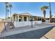 Attractive manufactured home with covered patio and palm trees at 120 N Val Vista Dr # 186, Mesa, AZ 85213