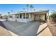 Mobile home with covered patio, white fence, and desert landscaping at 120 N Val Vista Dr # 186, Mesa, AZ 85213