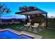Relaxing backyard oasis with pergola and seating area at 12079 E Cortez Dr, Scottsdale, AZ 85259