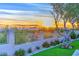 Scenic backyard view featuring a wall, grass, and sunset at 12079 E Cortez Dr, Scottsdale, AZ 85259