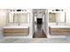 Bathroom featuring a double vanity and mirrors, and a view into the living area at 12079 E Cortez Dr, Scottsdale, AZ 85259