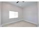 This bedroom features neutral carpet, fresh paint, and a single window for natural light at 12079 E Cortez Dr, Scottsdale, AZ 85259