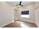 Bedroom featuring hardwood floors, natural light, and a built-in desk and shelves at 12079 E Cortez Dr, Scottsdale, AZ 85259