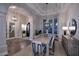 Spacious dining room with a large table, modern chandelier, and ample natural light at 12079 E Cortez Dr, Scottsdale, AZ 85259