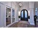 Bright and airy entryway with hardwood floors, a view into an office, and double doors at 12079 E Cortez Dr, Scottsdale, AZ 85259