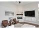Cozy living room features a brick fireplace, built-in entertainment center, and comfortable seating at 12079 E Cortez Dr, Scottsdale, AZ 85259