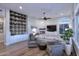 Open living room with a cozy fireplace, hardwood floors, and built-in shelving at 12079 E Cortez Dr, Scottsdale, AZ 85259