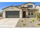 Two-story house with gray garage door and desert landscaping at 12800 N 172Nd Dr, Surprise, AZ 85388