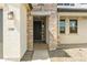 Front entrance with stone detailing and dark-colored door at 12800 N 172Nd Dr, Surprise, AZ 85388