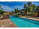Community pool and waterfall feature with stone deck and lounge chairs at 1331 W Baseline Rd # 251, Mesa, AZ 85202
